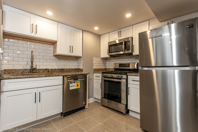 447 West 81st Street, Unit G Chicago, IL 60620 - Photo 2 of 20 a kitchen with stainless steel appliances granite countertop a refrigerator a stove and a sink