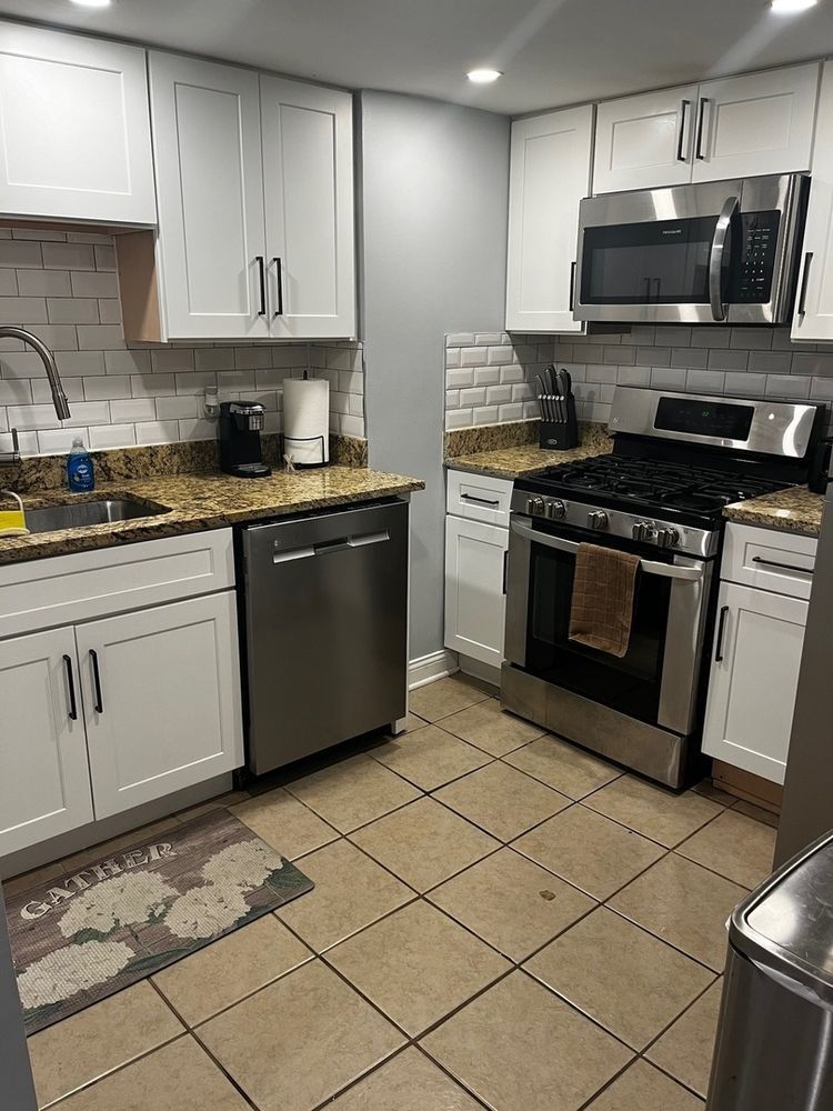 447 West 81st Street, Unit G Chicago, IL 60620 - Photo 4 of 20 a kitchen with stainless steel appliances granite countertop a stove a sink and a microwave