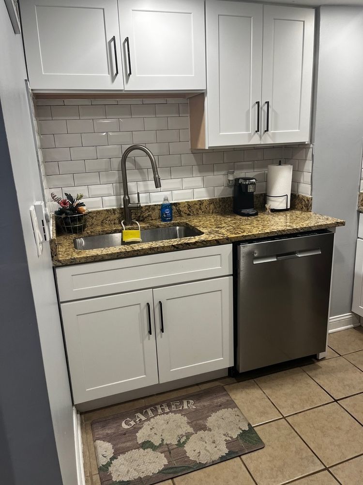 447 West 81st Street, Unit G Chicago, IL 60620 - Photo 5 of 20 a kitchen with stainless steel appliances granite countertop a sink stove and cabinets