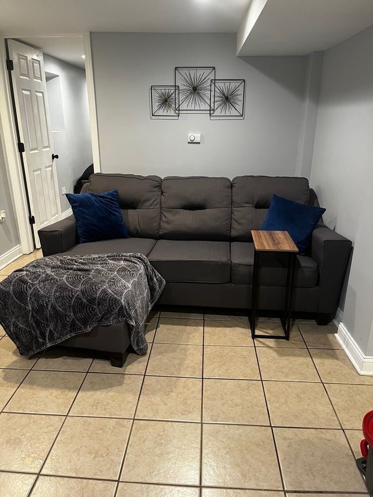 447 West 81st Street, Unit G Chicago, IL 60620 - Photo 10 of 20 a living room with a couch and a mirror