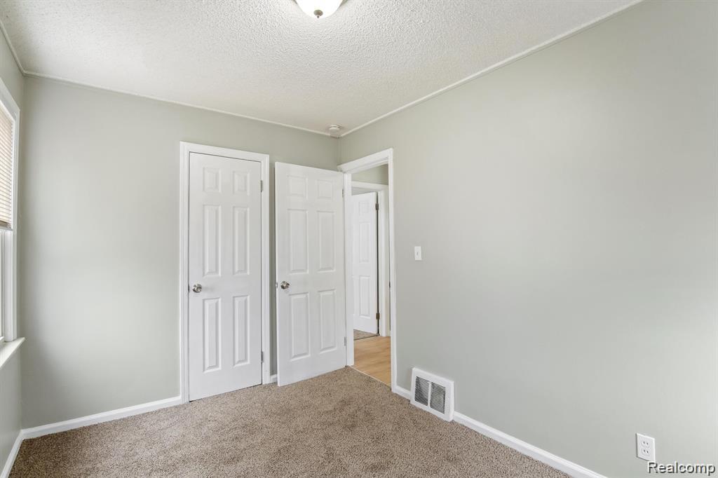 285 Campbell Street River Rouge, MI 48218 - Photo 13 of 33 Unfurnished bedroom featuring a textured ceiling, carpet floors, and a closet