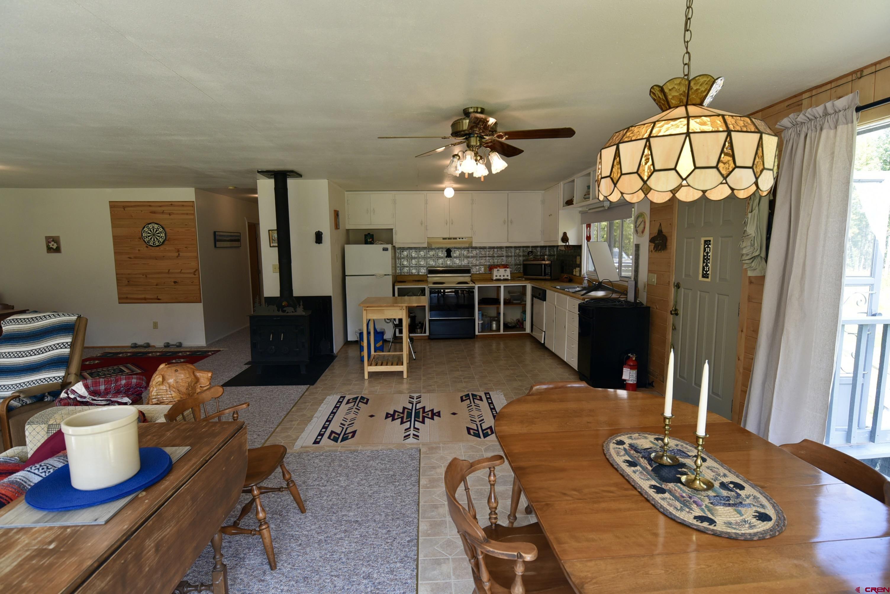 704 Hampton Road Montrose, CO 81220 - Photo 8 of 45 a living room with lots of furniture and a chandelier
