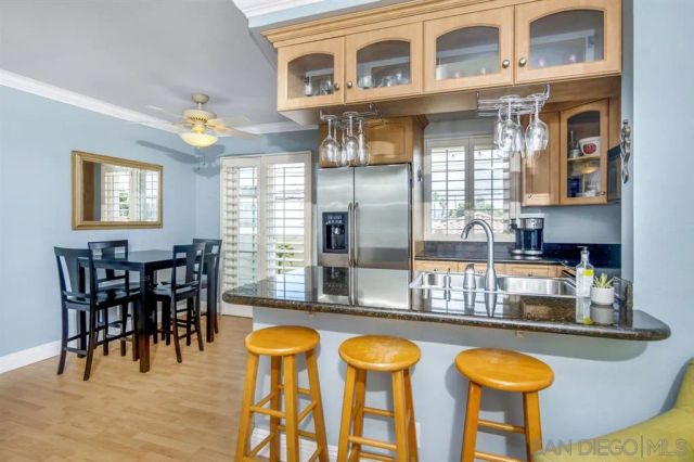 a view of a dining room kitchen with furniture and chandelier