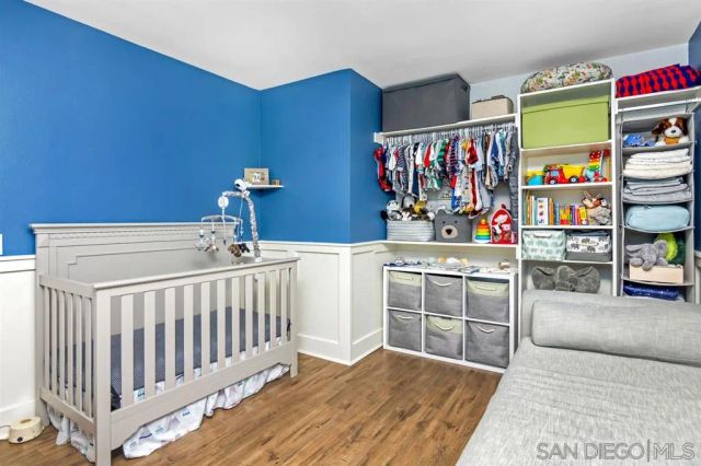a bedroom with furniture and baby crib