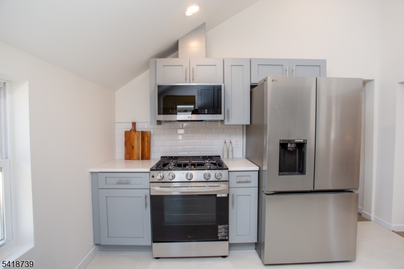 1434 Liberty Street Alpha, NJ 08865 - Photo 9 of 30 a kitchen with a stove microwave and refrigerator