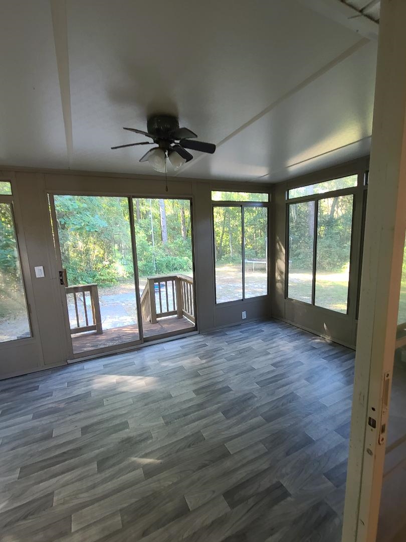 11996 Swooping Willow Road Jacksonville, FL 32223 - Photo 12 of 13 Unfurnished sunroom featuring wood finished floors and plenty of natural light