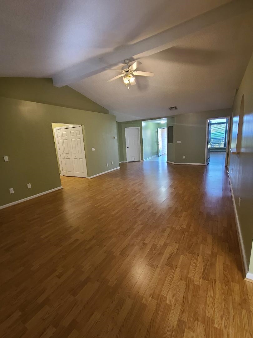 11996 Swooping Willow Road Jacksonville, FL 32223 - Photo 3 of 13 Unfurnished living room with dark wood finished floors and a ceiling fan