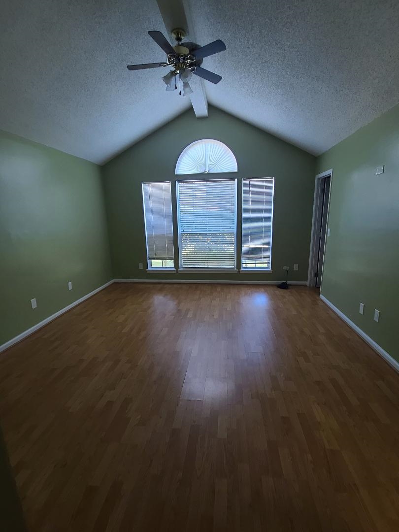 11996 Swooping Willow Road Jacksonville, FL 32223 - Photo 7 of 13 Spare room featuring dark wood finished floors, a ceiling fan, and a textured ceiling