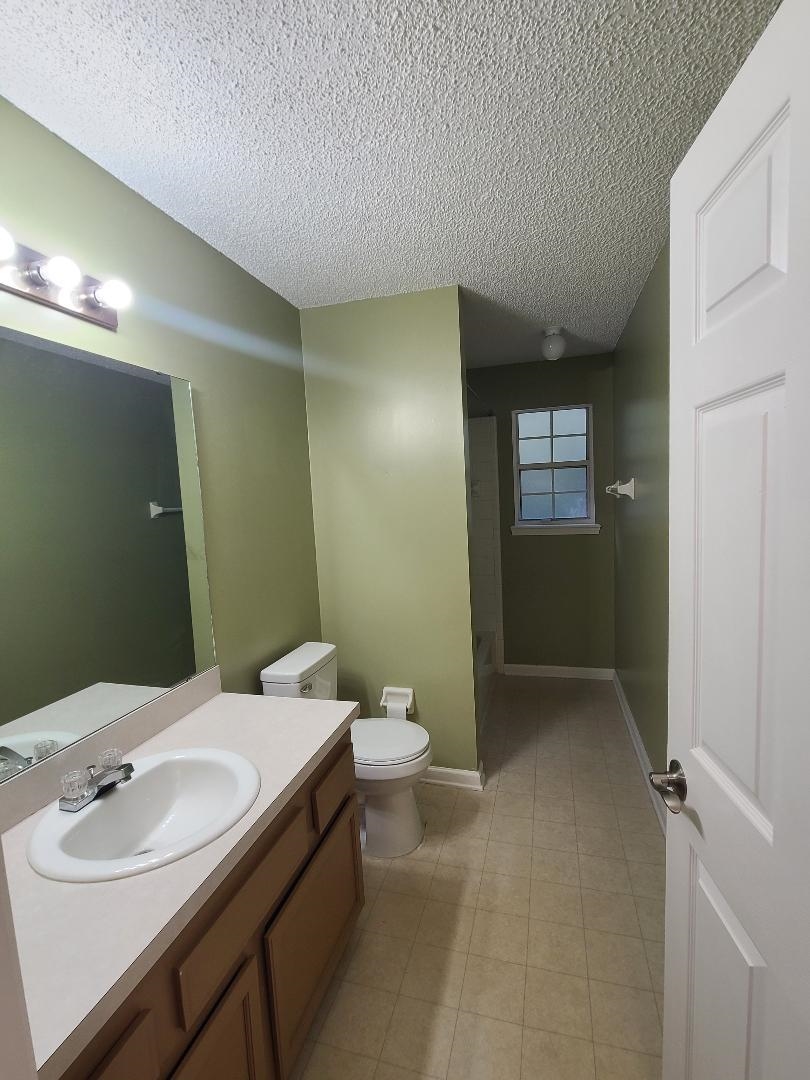 11996 Swooping Willow Road Jacksonville, FL 32223 - Photo 9 of 13 Bathroom with a shower stall, vanity, and a textured ceiling
