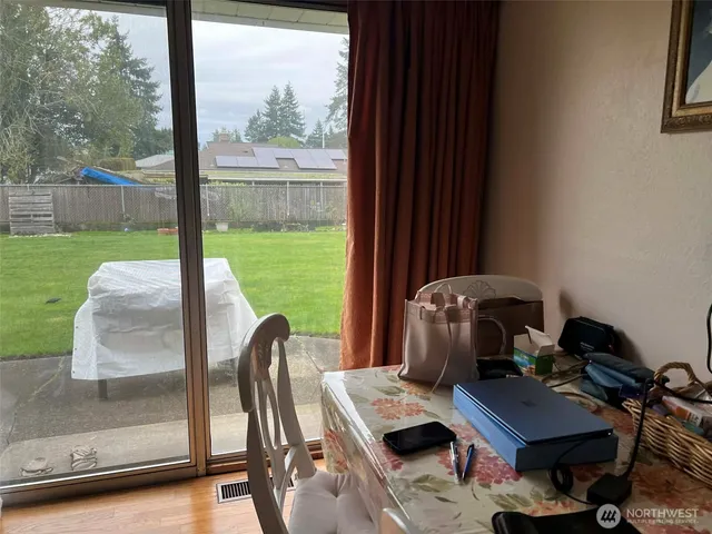 a backyard of a house with table and chairs