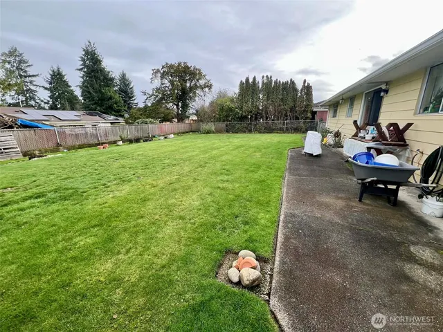a living room with furniture a flat screen tv and a window