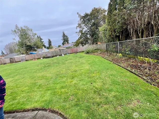 a view of a hallway with wooden floor and door