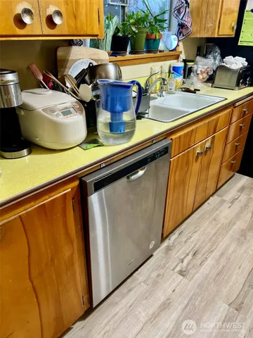 a view of a dining room with furniture a chandelier and wooden floor