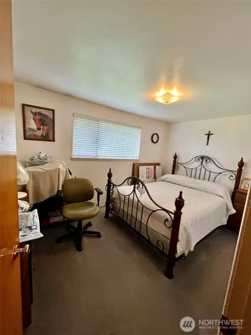 a bedroom with a bed and a desk