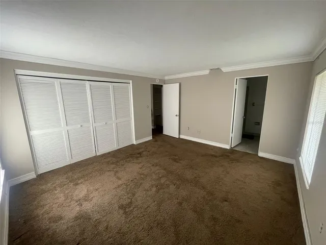 an empty room with closet area