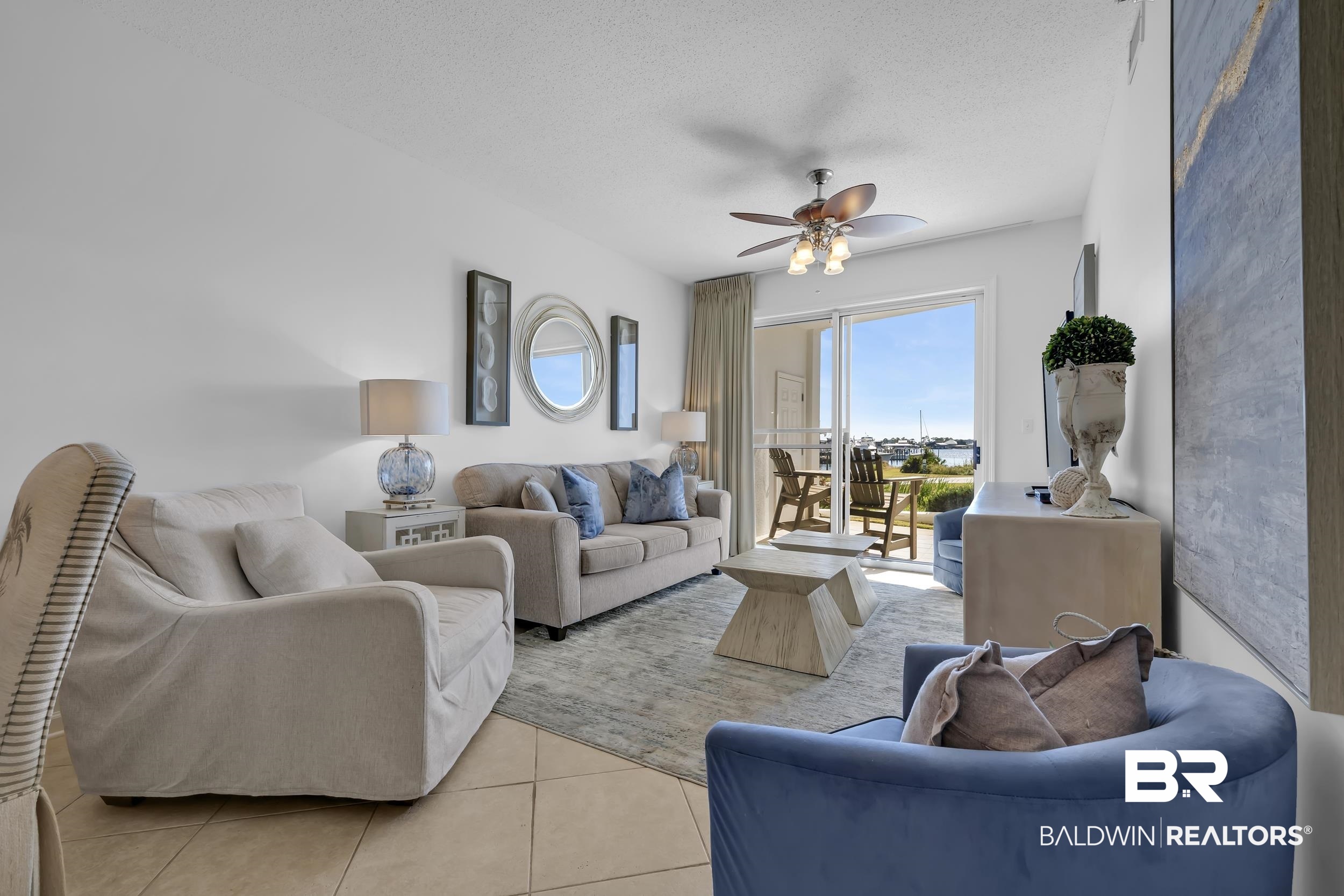27282 Canal Road, Unit 104 Orange Beach, AL 36561 - Photo 20 of 79 Tiled living room with a ceiling fan and a textured ceiling