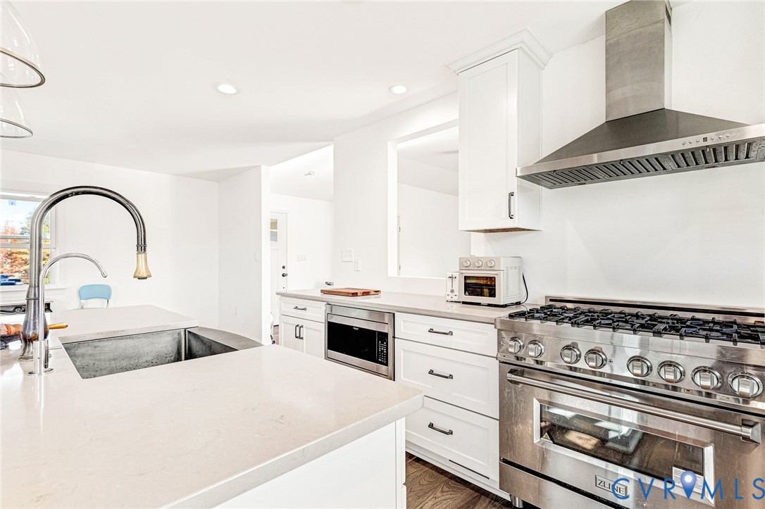 16307 Mountain Road Montpelier, VA 23192 - Photo 12 of 50 a kitchen with stainless steel appliances granite countertop a stove a sink and a white wooden cabinets