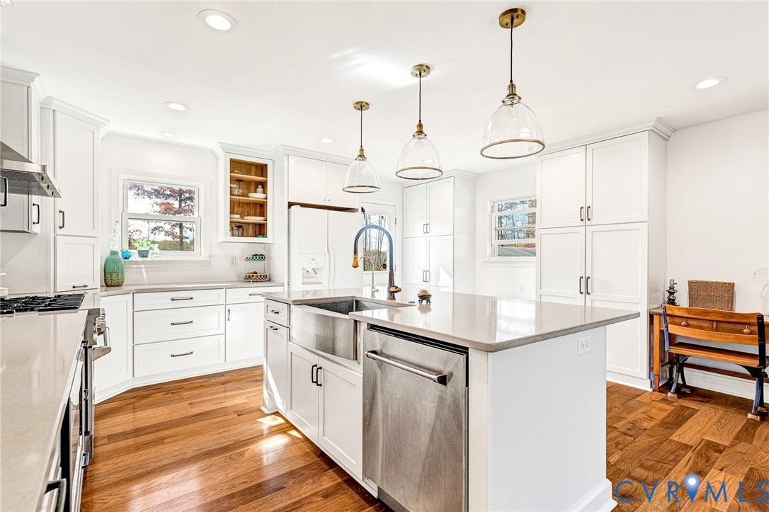 16307 Mountain Road Montpelier, VA 23192 - Photo 14 of 50 a large kitchen with kitchen island white cabinets and stainless steel appliances
