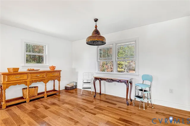 a living room with a piano and a table