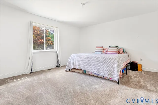 a bedroom with a bed and window