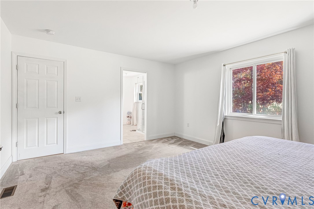 16307 Mountain Road Montpelier, VA 23192 - Photo 22 of 50 a bedroom with a bed and a window