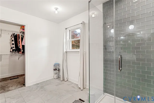 a spacious bedroom with a bed and a window