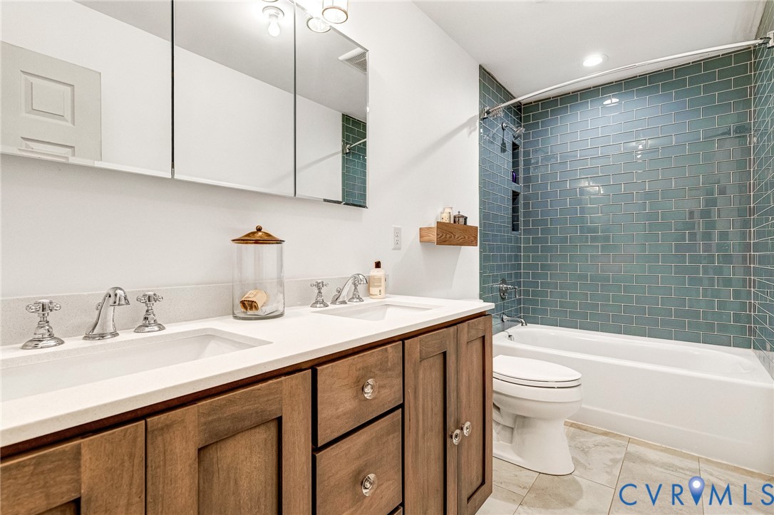 16307 Mountain Road Montpelier, VA 23192 - Photo 29 of 50 a bathroom with a sink a toilet and bathtub