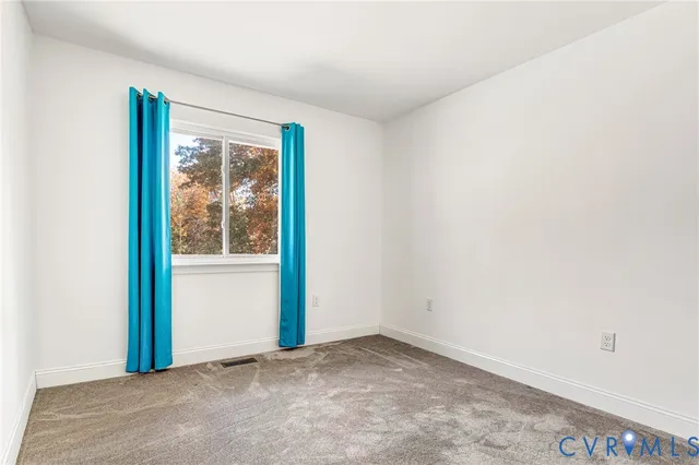 a view of an empty room with windows