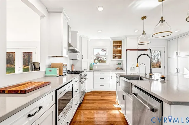 a kitchen with stainless steel appliances granite countertop a sink stove and cabinets