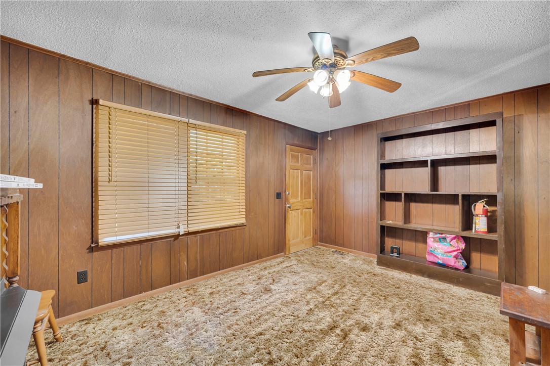 952 Stephens Drive Westminster, SC 29693 - Photo 21 of 50 A relaxed living area with warm wood paneling and practical built-in shelving.