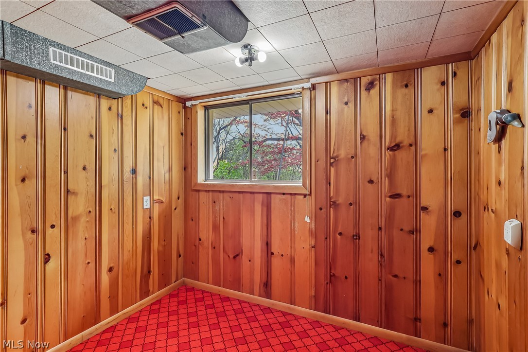 2060 6th Street Southwest Akron, OH 44314 - Photo 31 of 46 Lower level office with knotty pine walls and carpet flooring