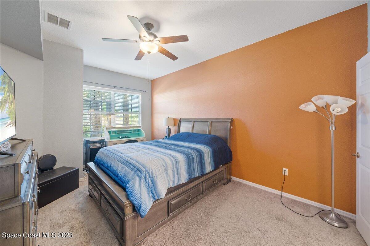 110 Colibri Way, Unit 107 Melbourne, FL 32901 - Photo 13 of 27 a bedroom with a bed and window