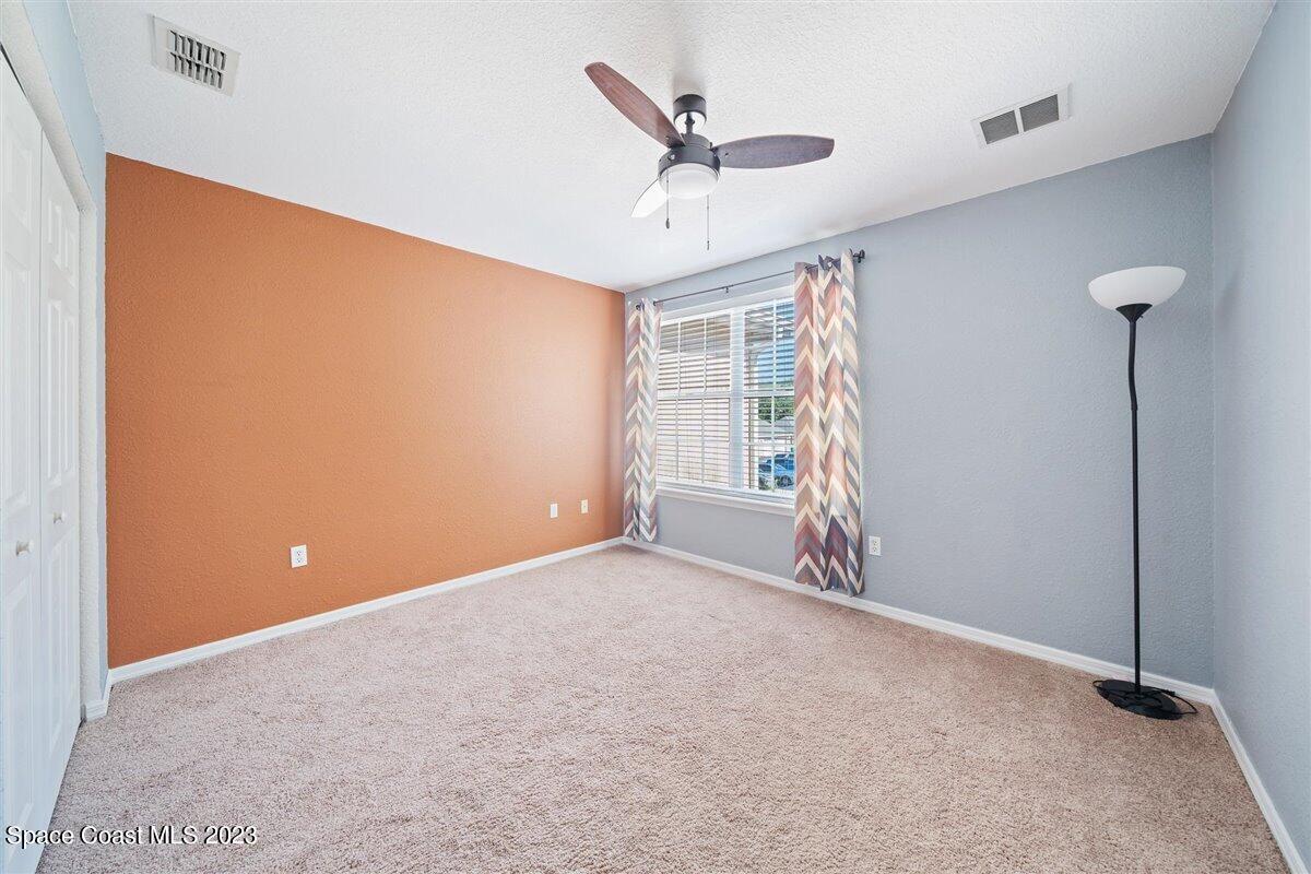 110 Colibri Way, Unit 107 Melbourne, FL 32901 - Photo 16 of 27 a view of an empty room with a ceiling fan