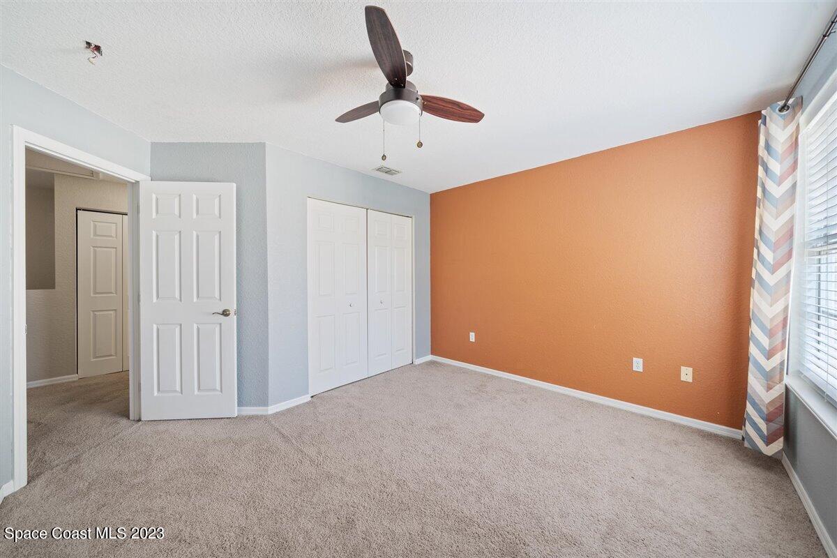 110 Colibri Way, Unit 107 Melbourne, FL 32901 - Photo 17 of 27 a view of an empty room with a ceiling fan