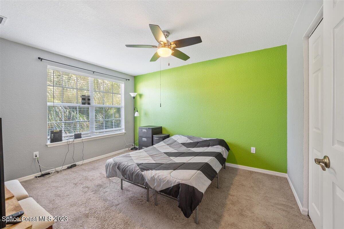 110 Colibri Way, Unit 107 Melbourne, FL 32901 - Photo 20 of 27 a bedroom with a bed and a window