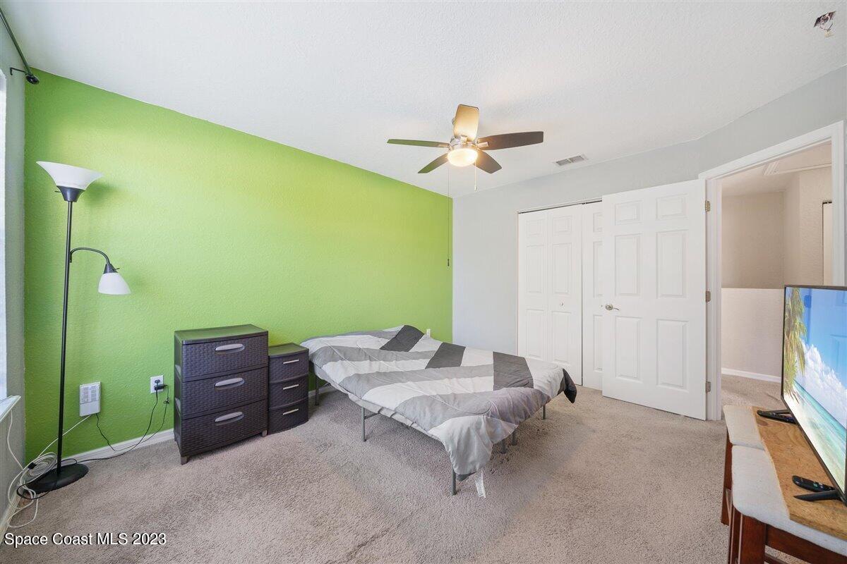 110 Colibri Way, Unit 107 Melbourne, FL 32901 - Photo 21 of 27 a living room with furniture and a flat screen tv