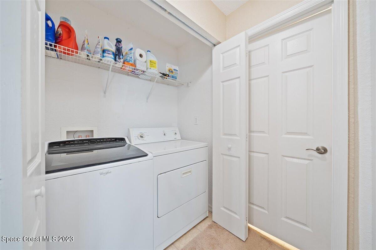 110 Colibri Way, Unit 107 Melbourne, FL 32901 - Photo 22 of 27 a utility room with dryer and washer
