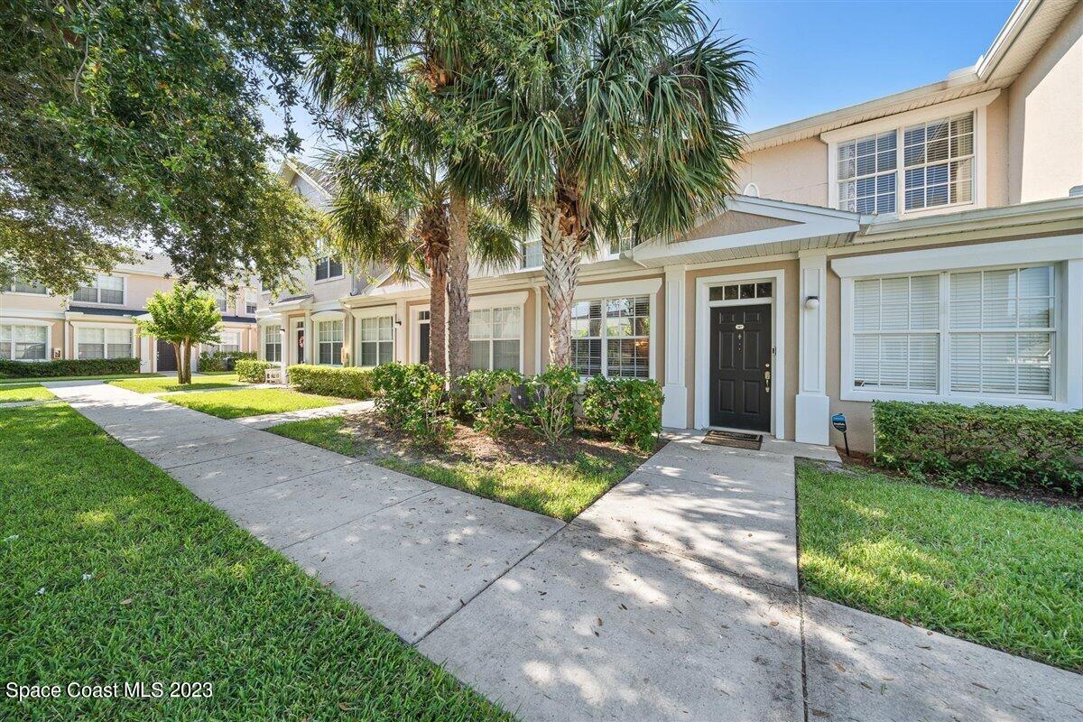110 Colibri Way, Unit 107 Melbourne, FL 32901 - Photo 3 of 27 a front view of a house with garden and porch