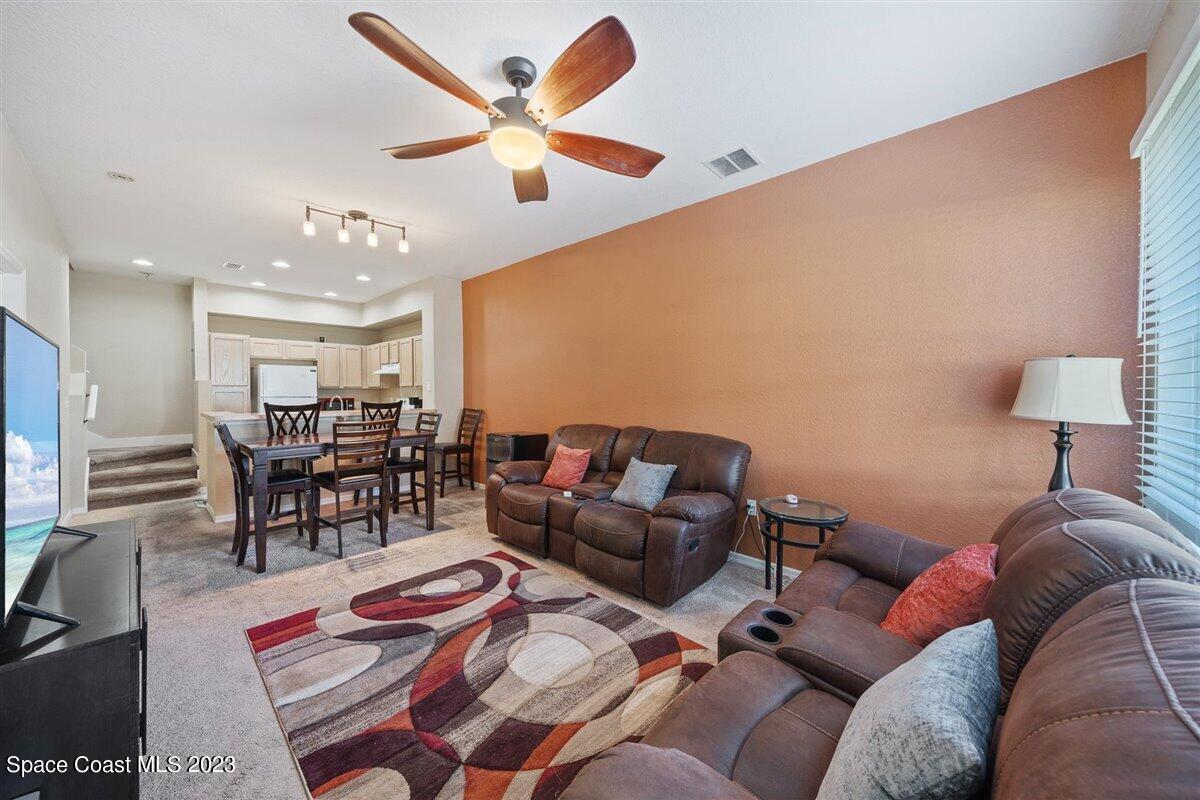 110 Colibri Way, Unit 107 Melbourne, FL 32901 - Photo 5 of 27 a living room with furniture and view of kitchen