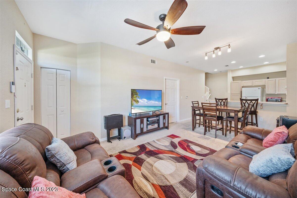 110 Colibri Way, Unit 107 Melbourne, FL 32901 - Photo 6 of 27 a living room with furniture and a view of dining room