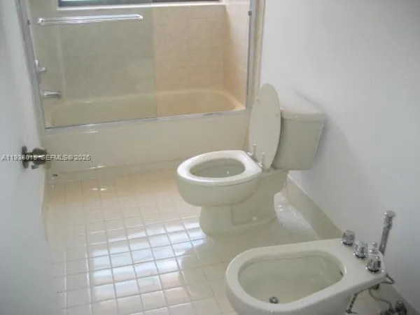 a bathroom with a toilet and a bathtub