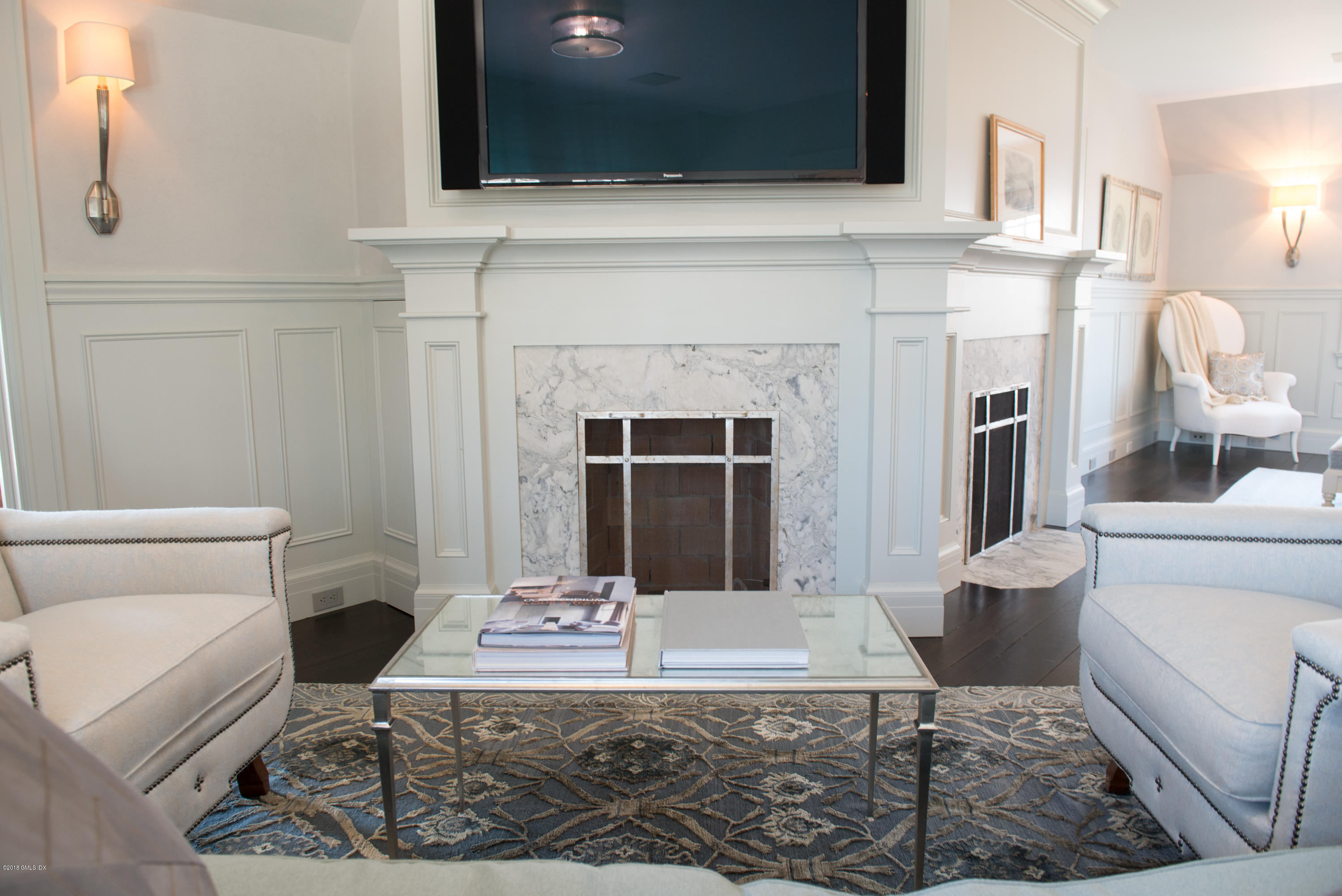47 Carriglea Drive Riverside, CT 06878 - Photo 12 of 49 a living room with furniture a fireplace and a flat screen tv