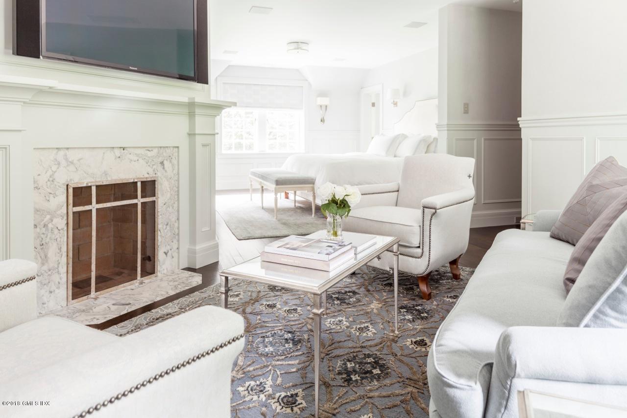 47 Carriglea Drive Riverside, CT 06878 - Photo 13 of 49 a living room with furniture a fireplace and a table