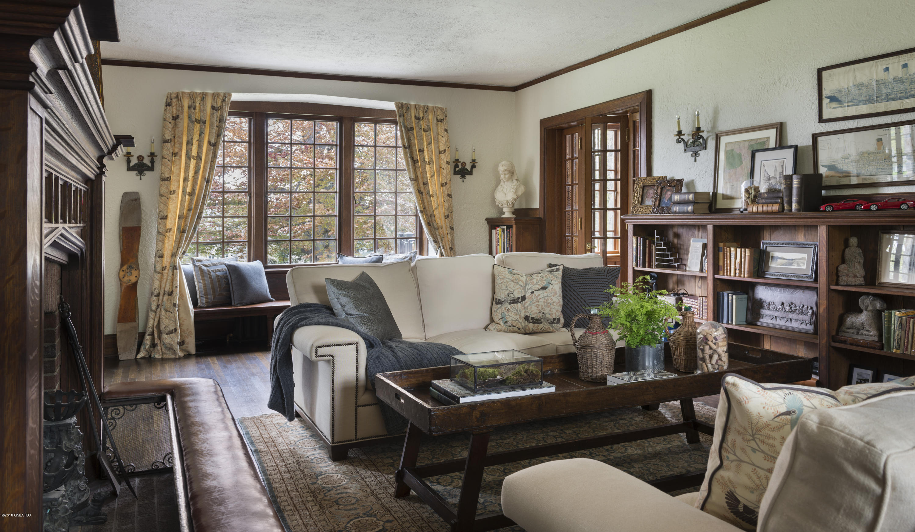 47 Carriglea Drive Riverside, CT 06878 - Photo 27 of 49 a living room with furniture a bookshelf and a window