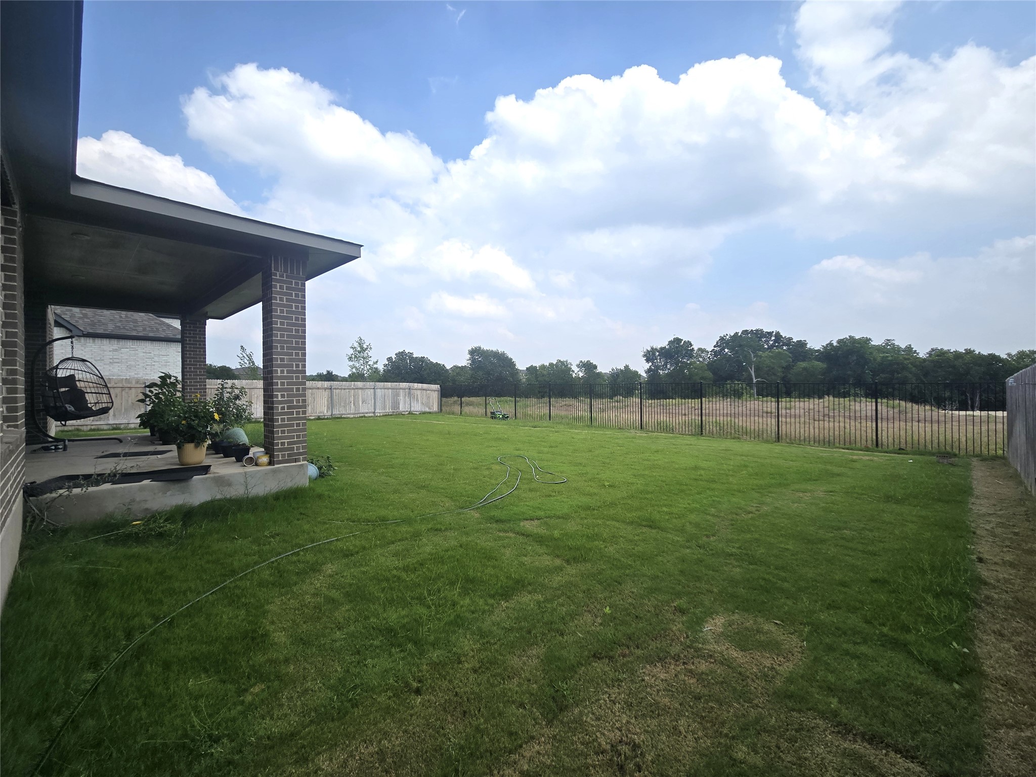 124 Ribera Drive Liberty Hill, TX 78642 - Photo 27 of 40 A spacious backyard with a covered patio offers ample outdoor living potential and privacy.
