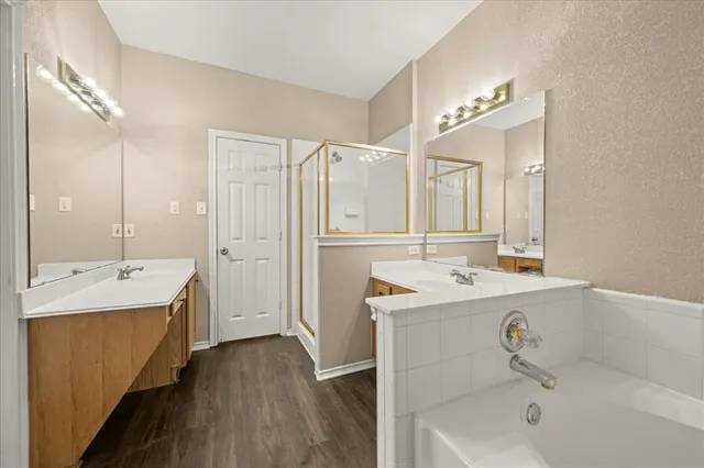 a bathroom with a tub sink and mirror