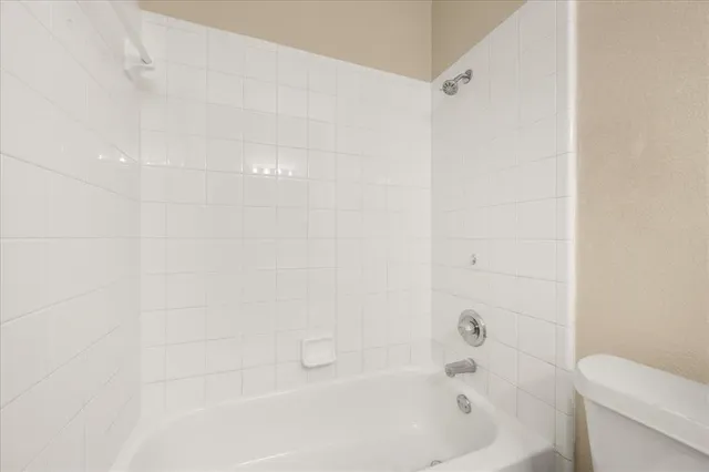 a bathroom with a bathtub and a toilet