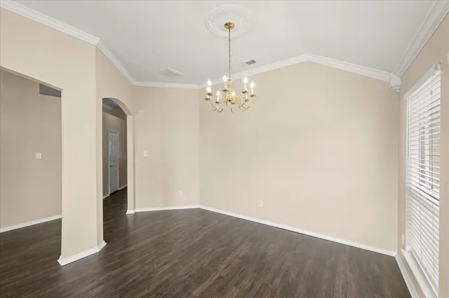 a view of a room with wooden floor and a window