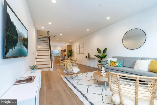 a living room with furniture and a potted plant
