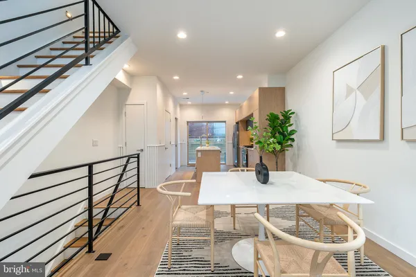 a dining room with furniture and wooden floor